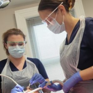 dentist and dental nurse working chairside