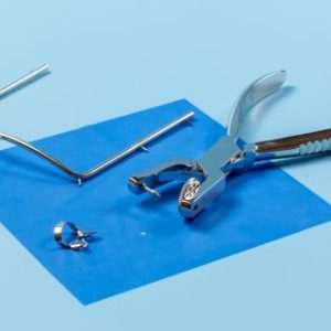 dental rubber dam and instruments on a blue background